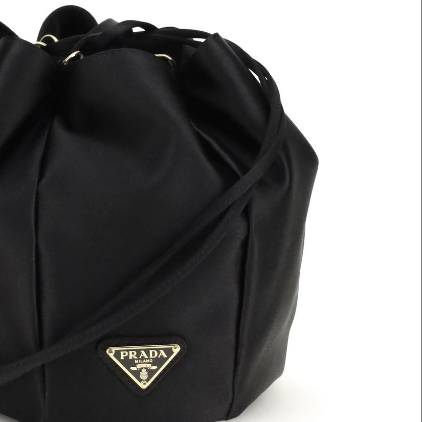 Prada satin mini bucket bag black with triangle logo close up